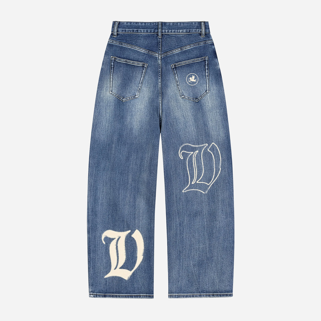 Blue jeans with white letter 'V' design on a light gray background