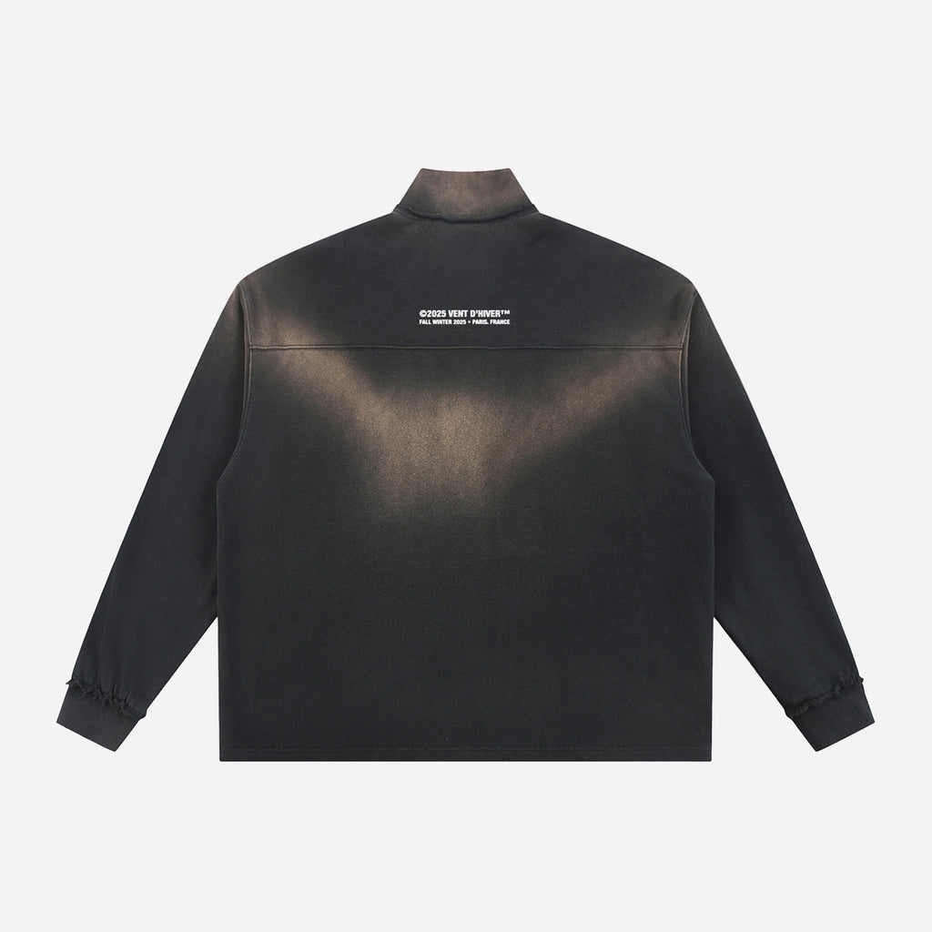 Black quarter-zip with a logo on the back against a white background