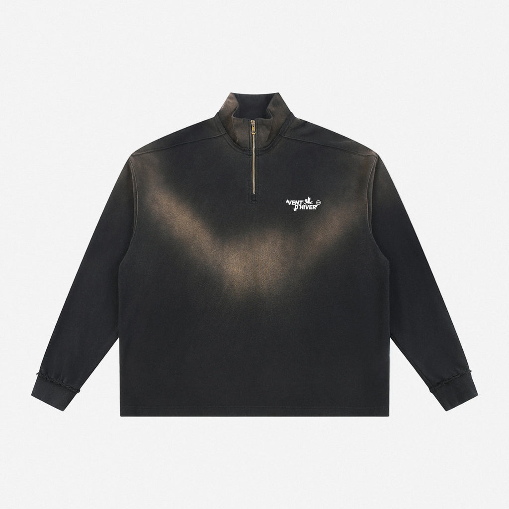 Black quarter-zip with a logo on a white background